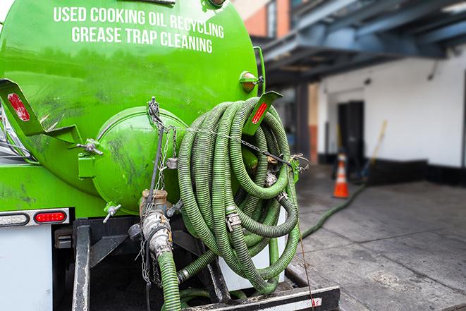 a professional technician pumping a restaurant's grease trap in Christopher, IL